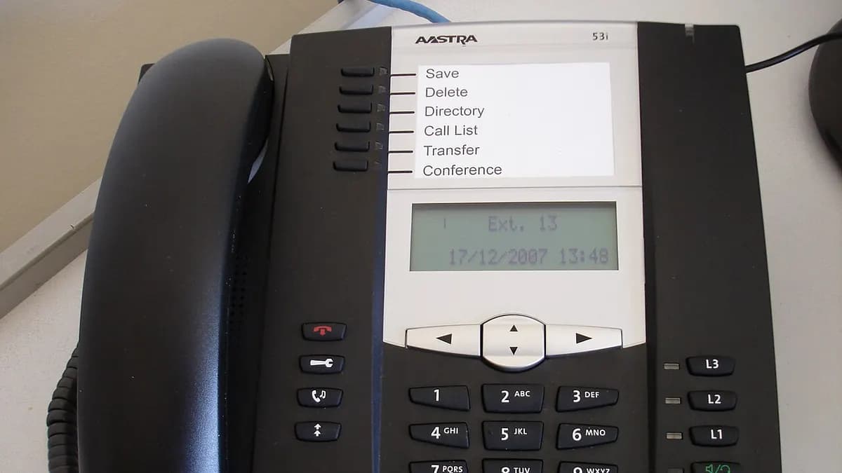 Desk IP telephone with a keypad and a small display