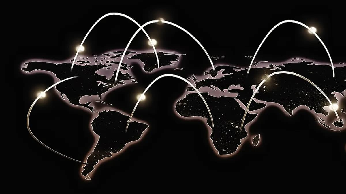 World map at night with arcs of light connecting the continents