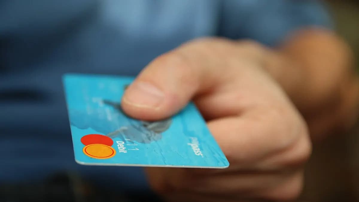 Hand holding out a payment card