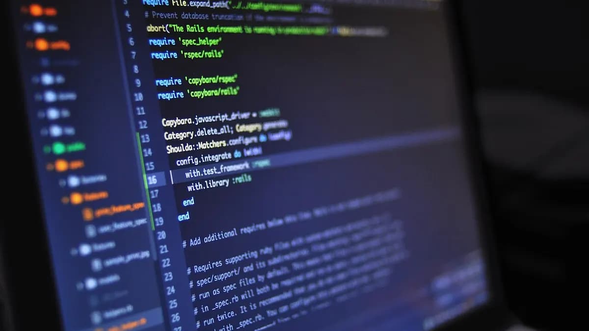Code editor with a file tree and source code on a laptop screen