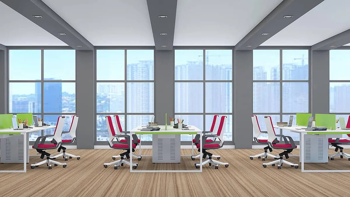 Bright open-plan office with rows of desks and chairs